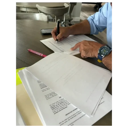 Man signing estate planning documents with a mobile notary.